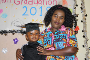 Mom and son in front of graduation sign