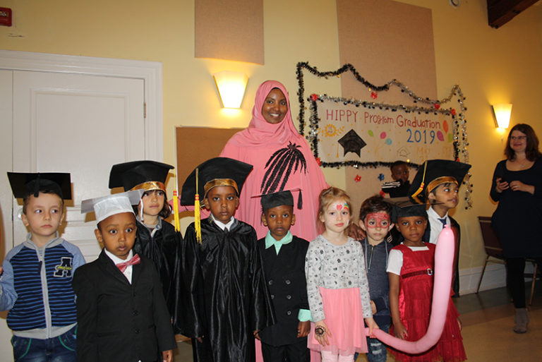 A group of graduates gather with one of the instructors