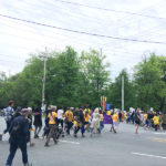 People crossing the street during the Walk with Refugees