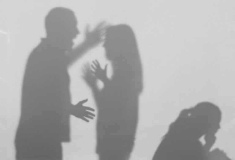 Silhouettes of quarreling parents and little child on white background. Domestic violence concept