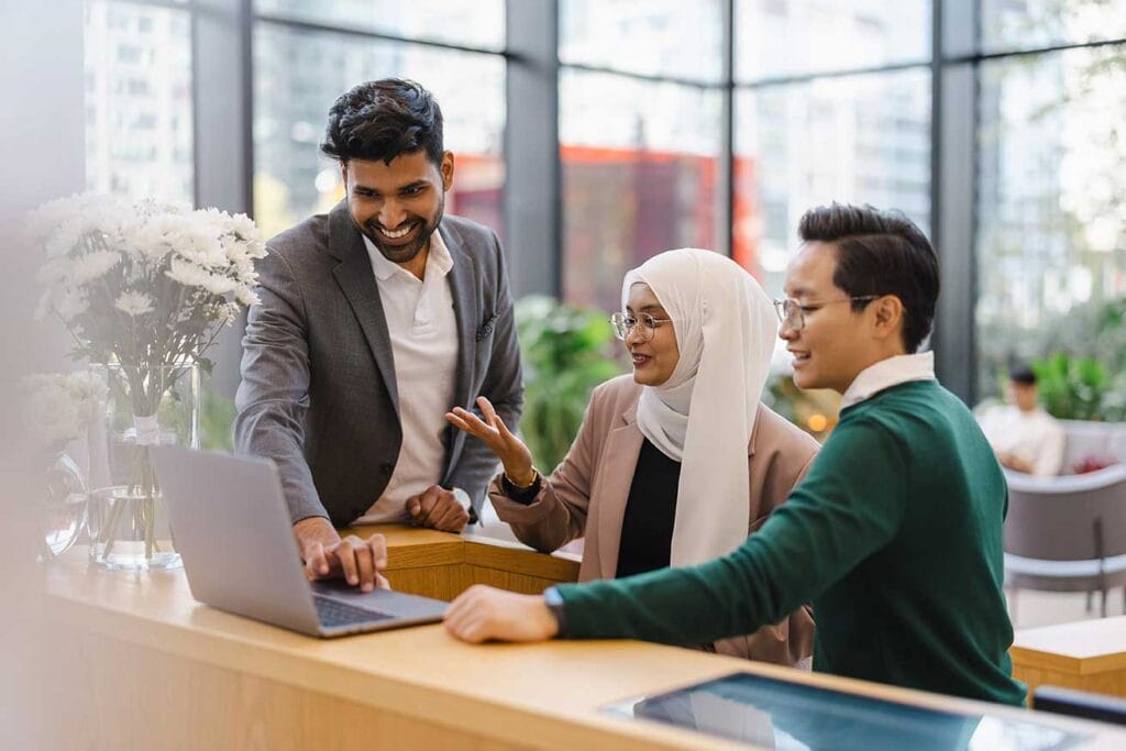 Multicultural group working together in front of laptop