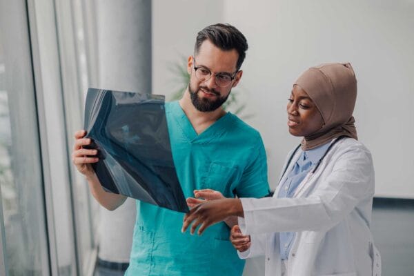 Two internationally trained medical professionals looking at xray