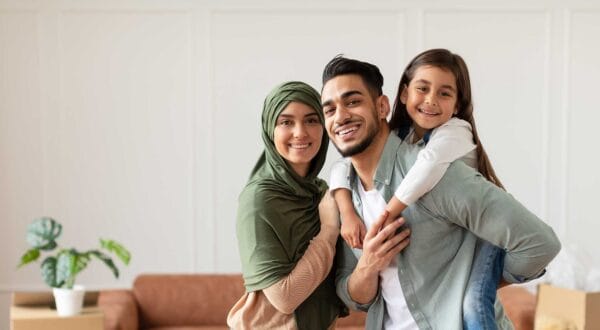 Newcomers family smiling and enjoying their new home