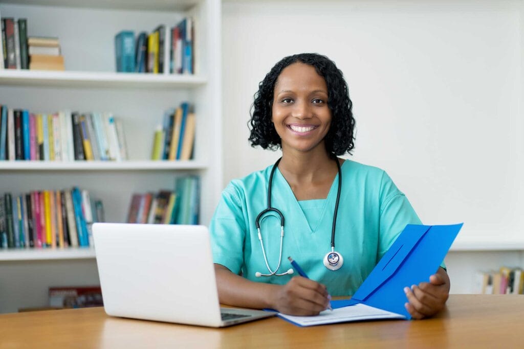 An internationally trained nurse smiling and writing a report