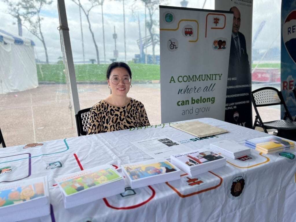 Volunteer smiling at the front desk