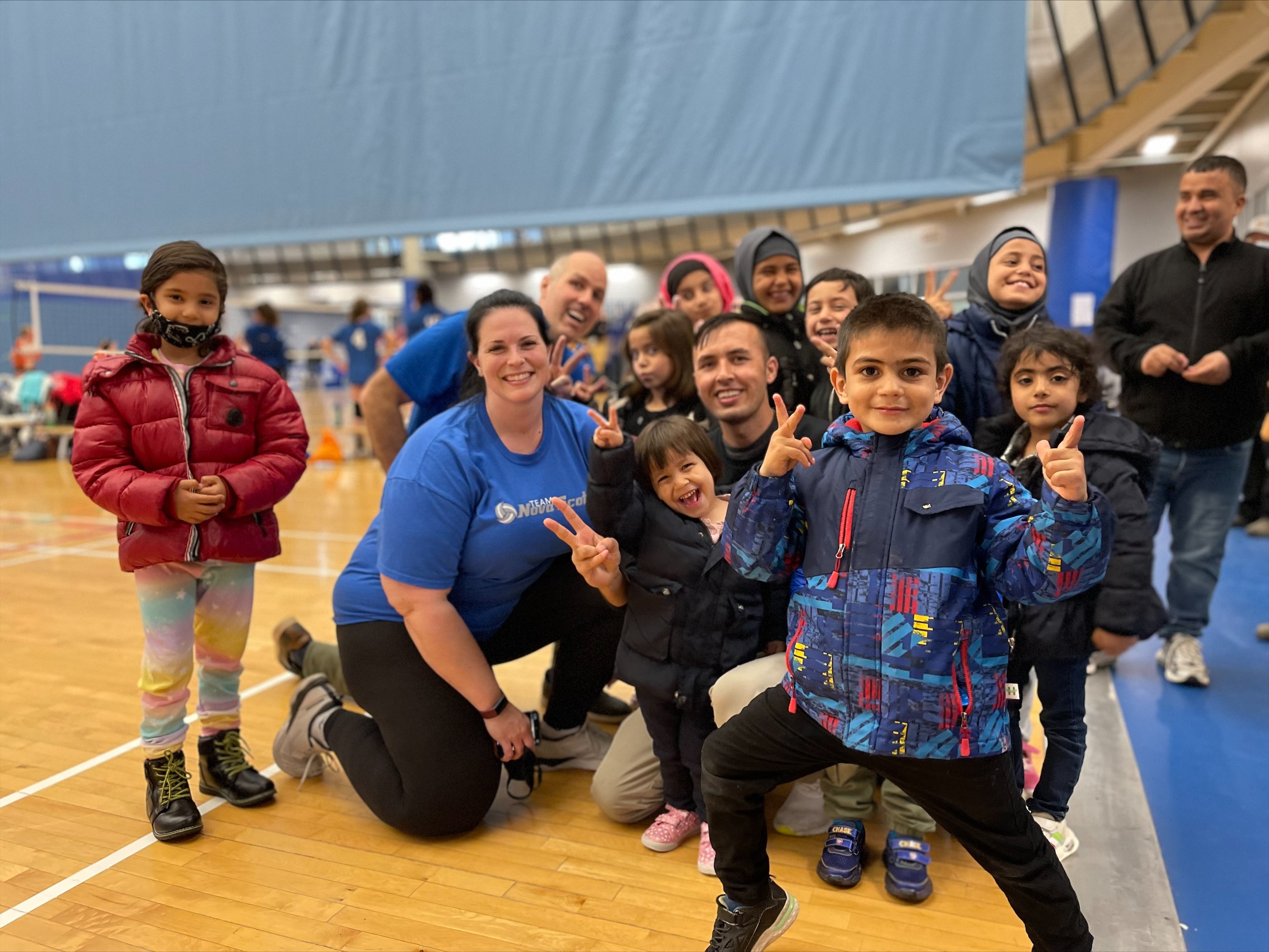 Hadayat Rahimi (center) with his volleyball colleagues and youth team.