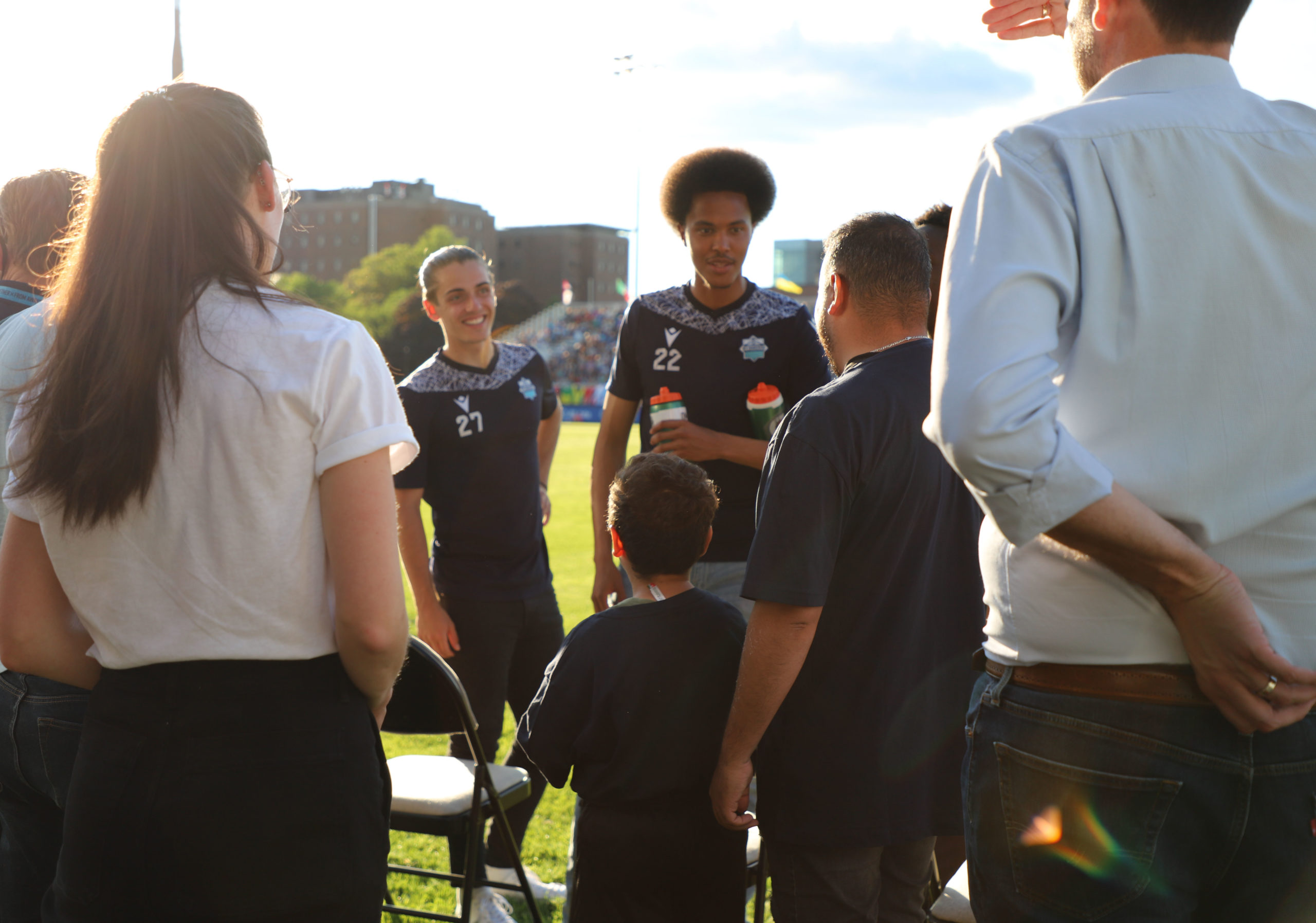 Muhammed Kelzi and his father Ibrahim chat with some of the Wanderers players.