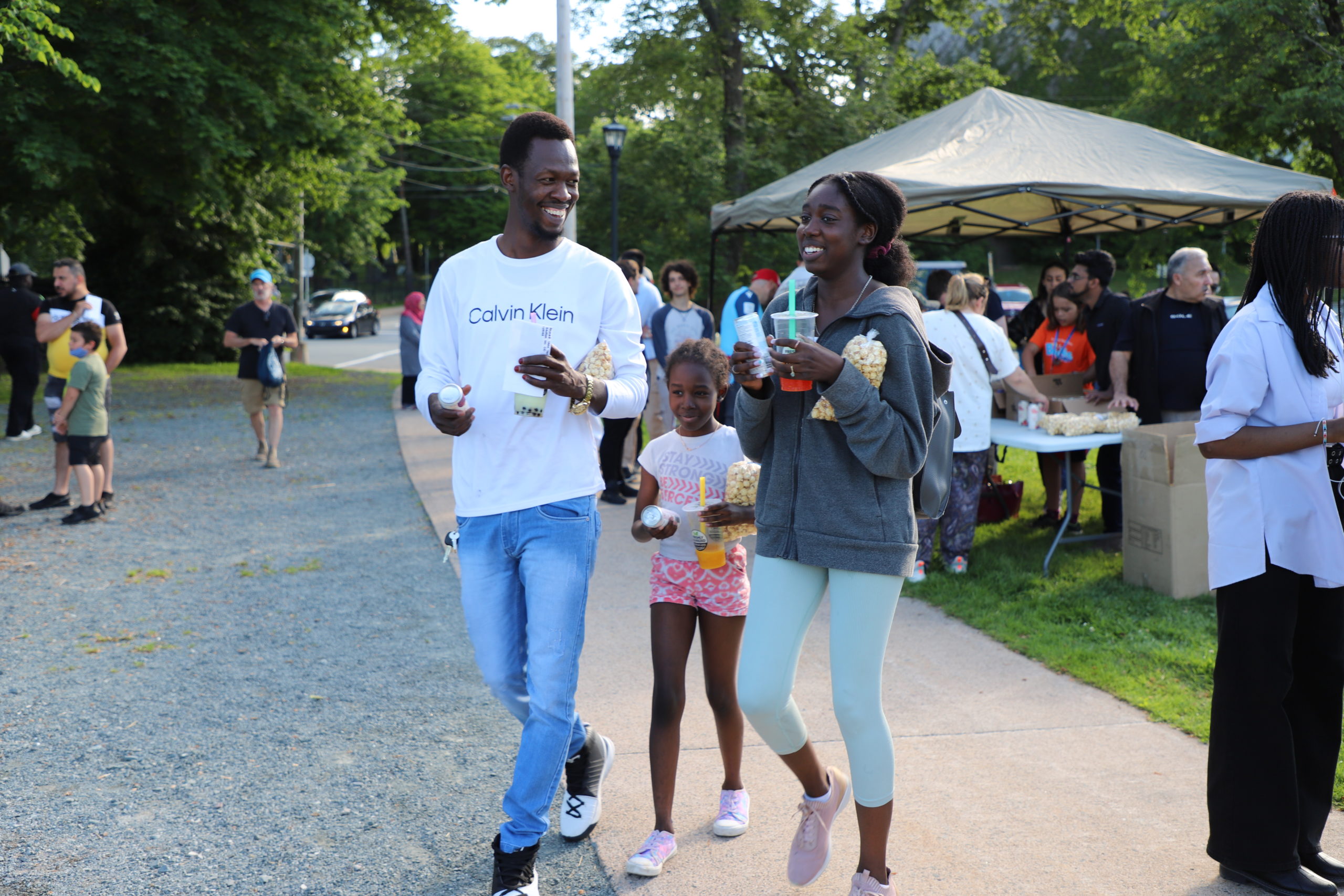 Popcorn and drinks in hand, ISANS clients head toward the Wanderers stadium.