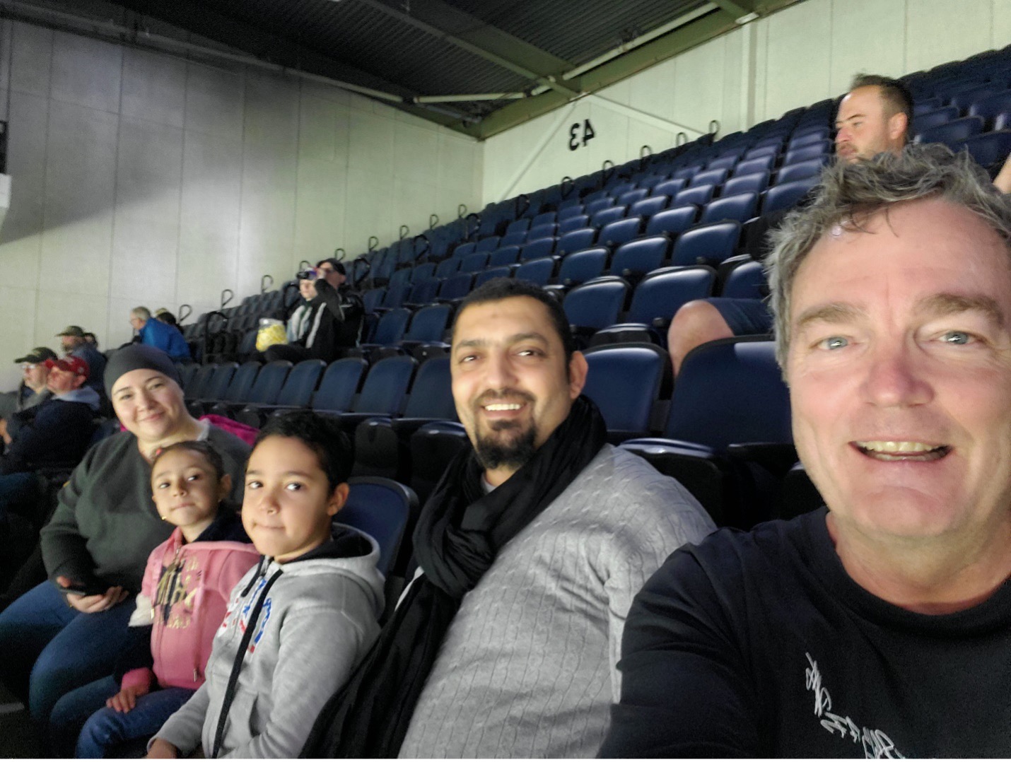 Toufik and his family during the Moosehead game with a volunteer