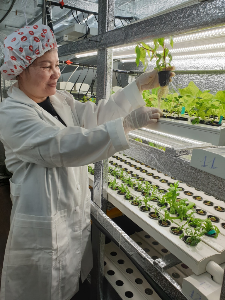 Tuson's wife Natalie is working in the indoor garden built by VCATIP.