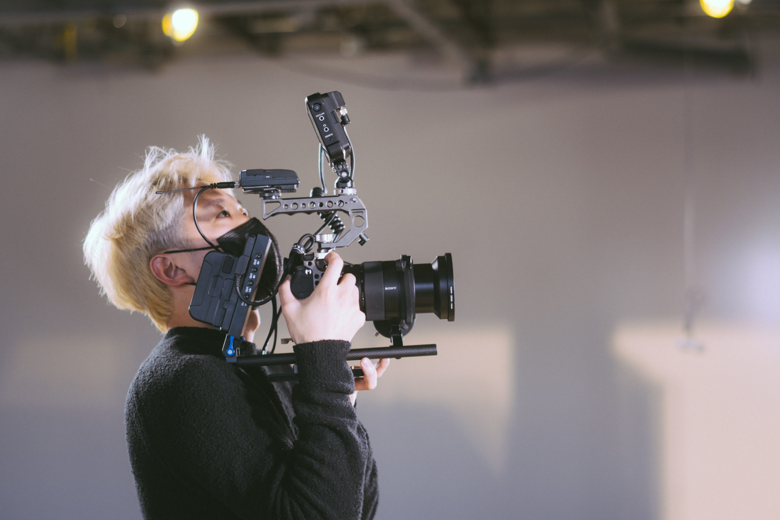 Will, the owner of Halitube working while holding a film camera