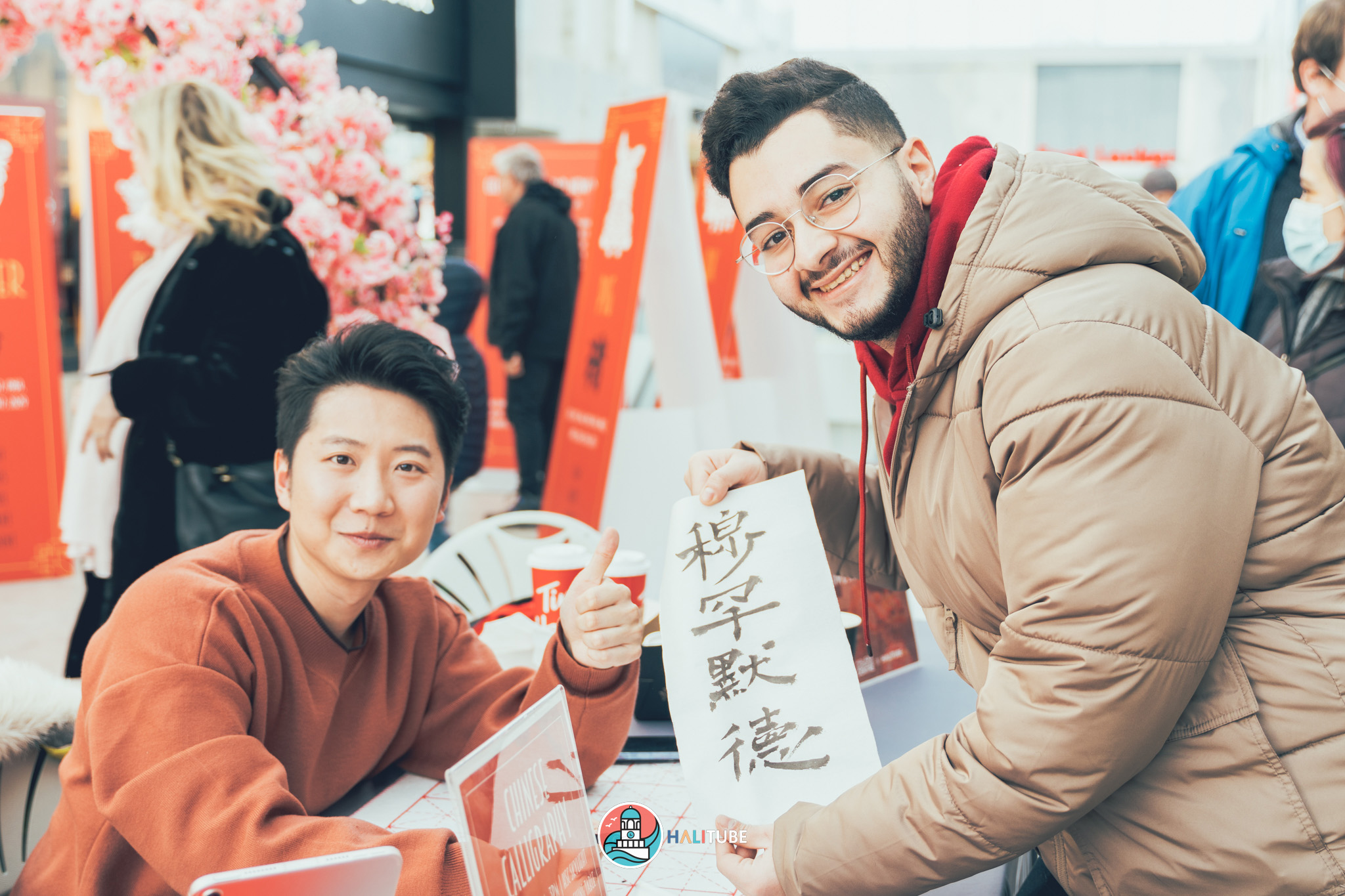 Will writes calligraphy to raise money for Feed Nova Scotia during Lunar New Year festival at the Halifax Shopping Centre.