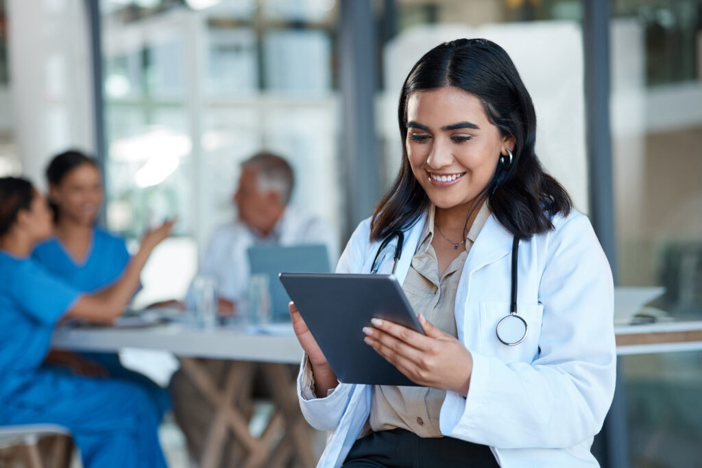 Hospital doctor and Indian woman on tablet for medical analysis research and report in meeting Healthcare clinic and female nurse on digital tech for wellness app online consulting and service
