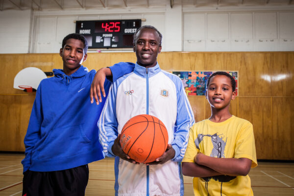 2 youths and 1 adult male inside basketball gym