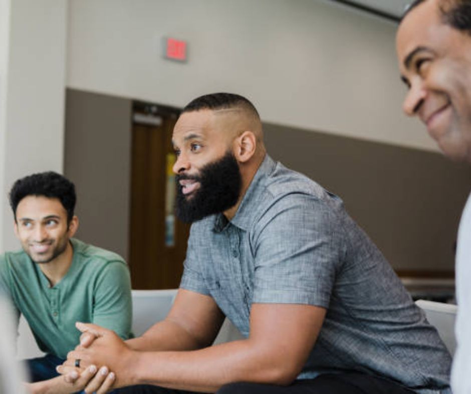 Three immigrant men attending the program.