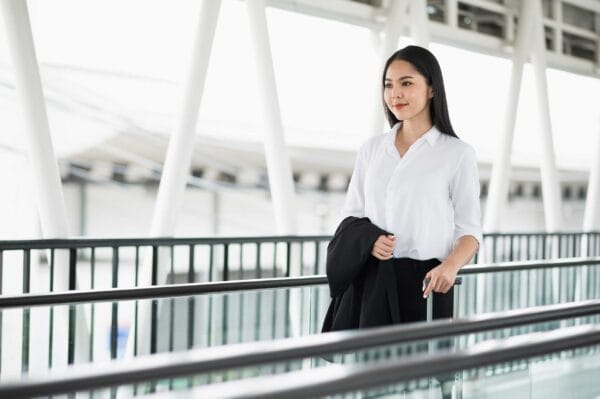 A newcomer female immigrant holding her luggage in the airport