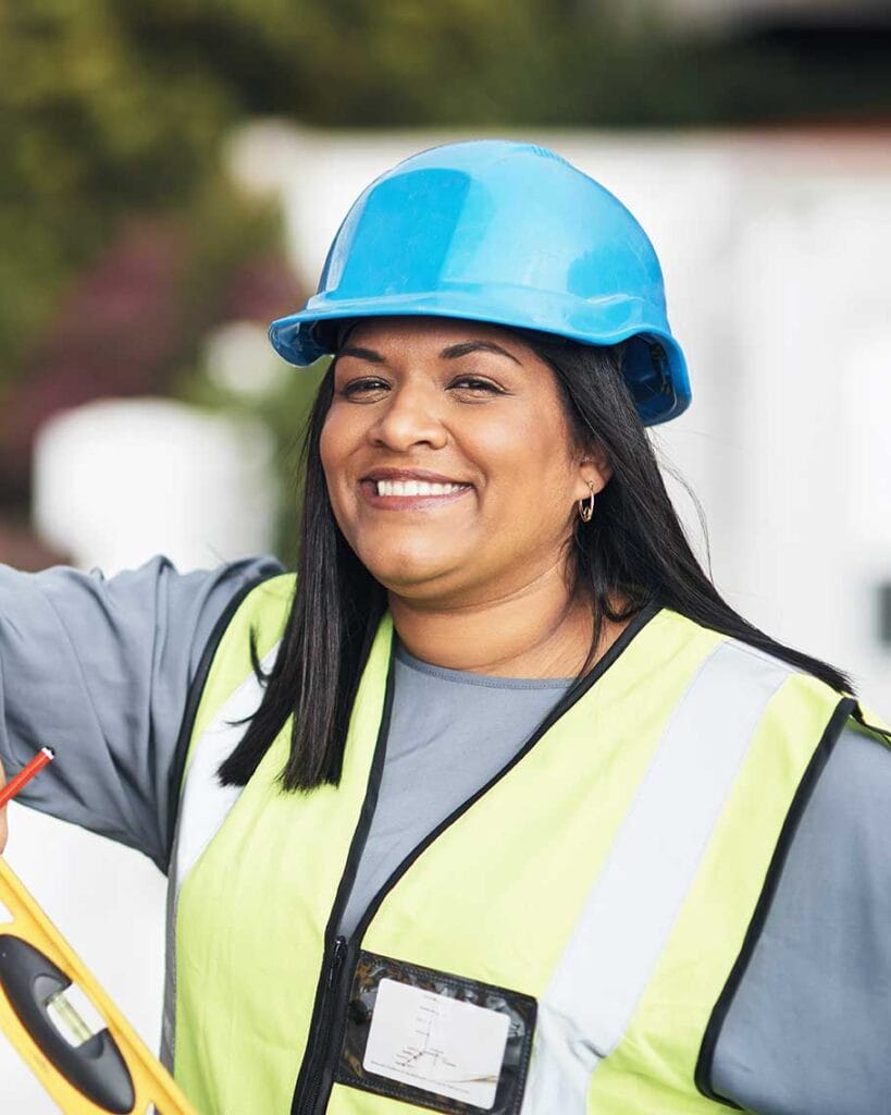 Immigrant female construction worker smiling