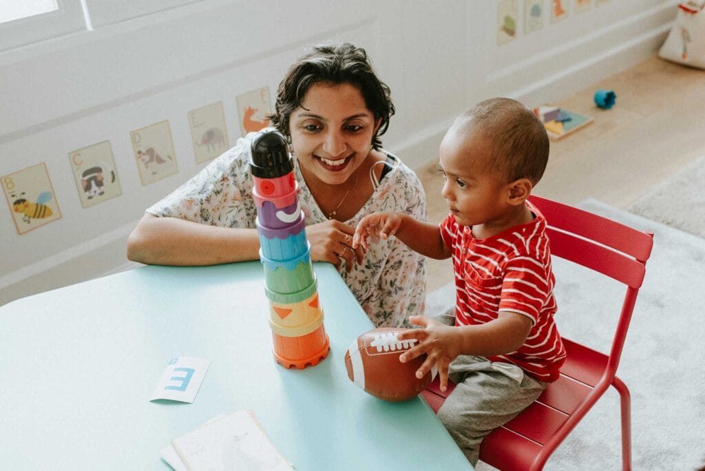 An immigrant woman and child playing with toys