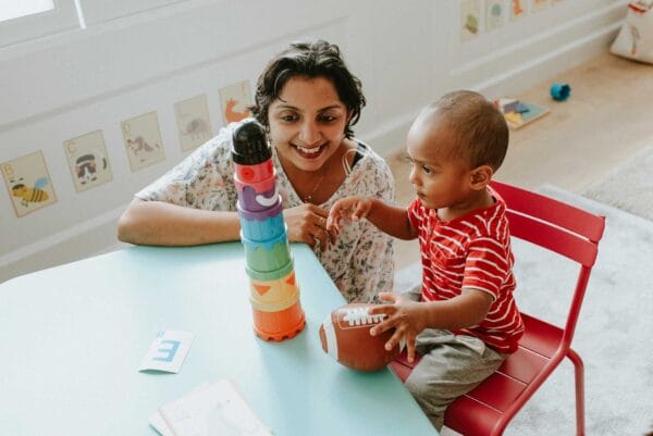 An immigrant woman and child playing with toys