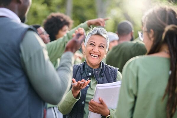 A newcomer immigrant talking to a group of people during a community event