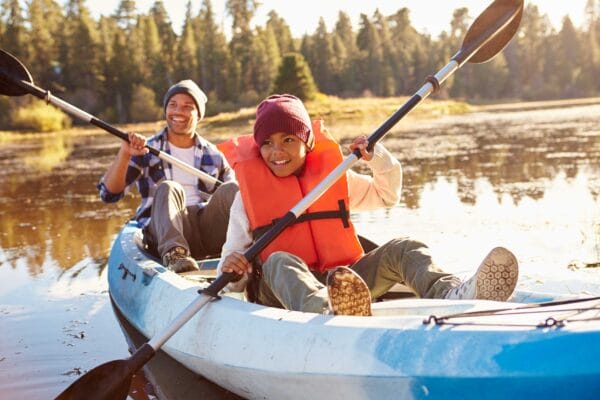 Father and son kayaking on a lake