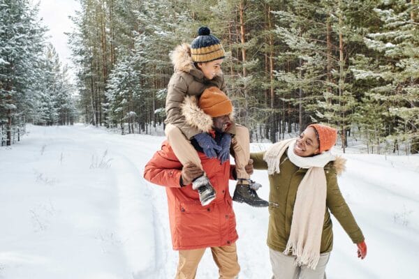 Immigrant family wearing winter clothes and enjoying the snow
