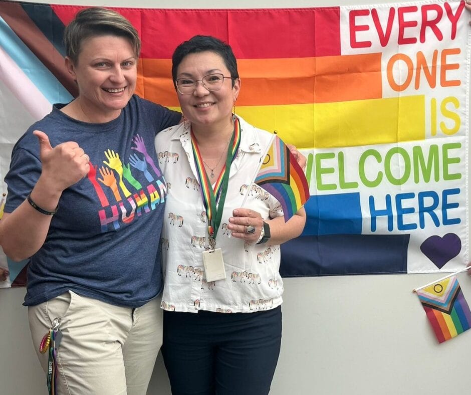 Naida and Aya with the pride flag