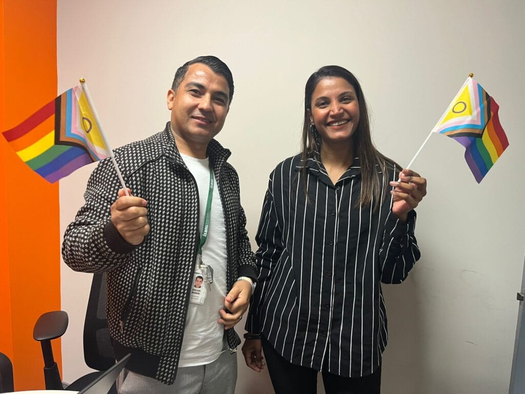 ISANS staff holding Pride banners