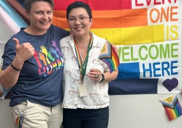 Naida and Aya with the pride flag