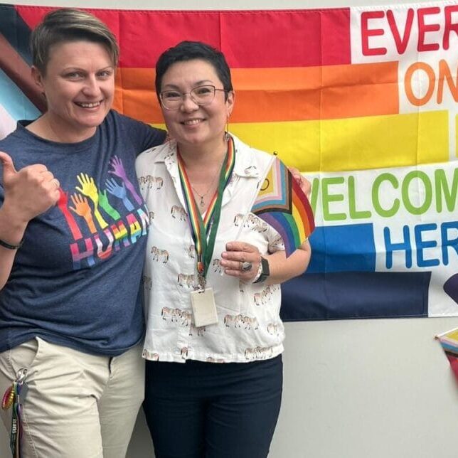 Naida and Aya with the pride flag