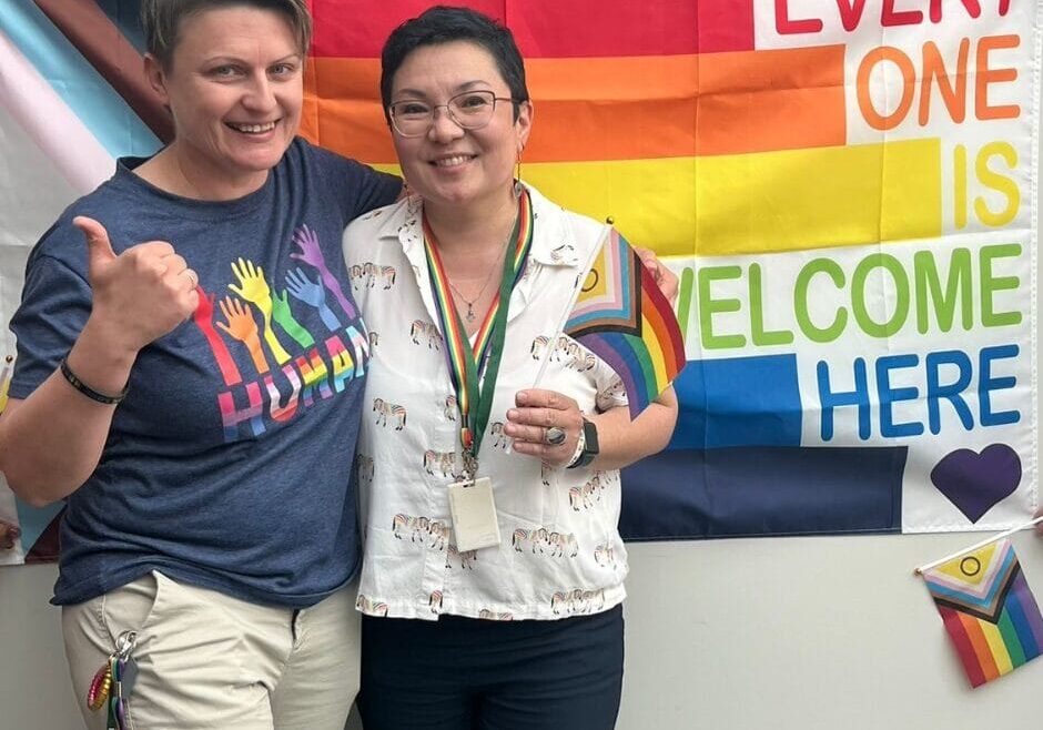 Naida and Aya with the pride flag