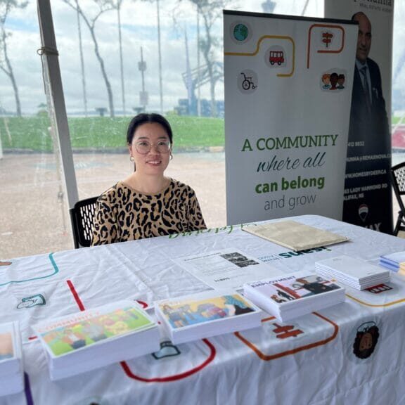 Volunteer smiling at the front desk