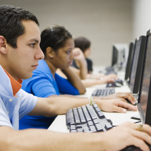 a multiethnic group of students working on computers in a computer lab
