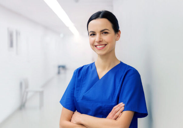 A happy internationally educated female nurse standing in a hospital