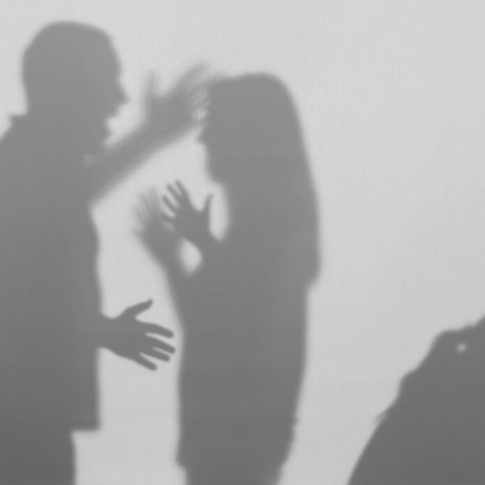 Silhouettes of quarreling parents and little child on white background. Domestic violence concept