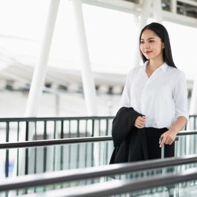 A newcomer female immigrant holding her luggage in the airport