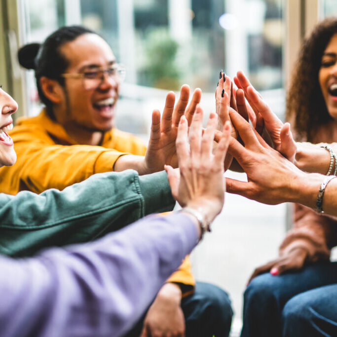 Multiracial happy young people stacking hands-Group of diverse f