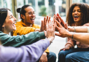 Multiracial happy young people stacking hands-Group of diverse f