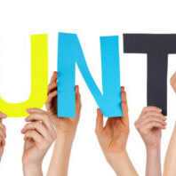Many Caucasian People And Hands Holding Colorful Straight Letters Or Characters Building The Isolated English Word Volunteer On White Background