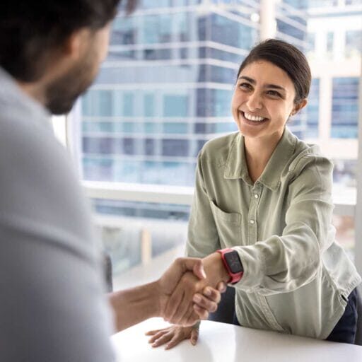 A skilled foreign worker shaking hands with employer during a job interview