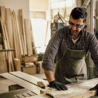 An immigrant carpenter working with wood
