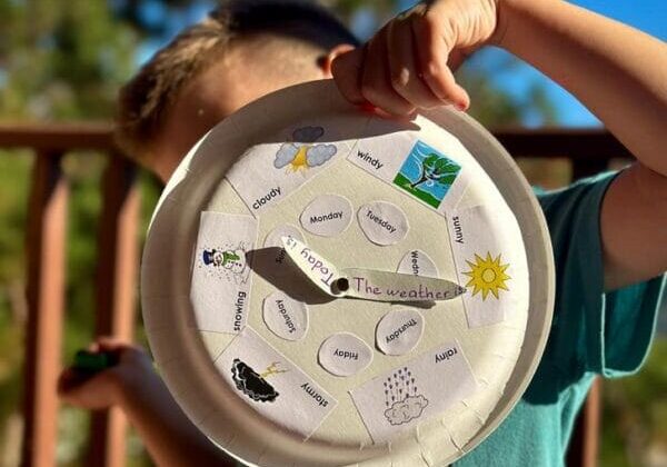 A child holding a paper clock