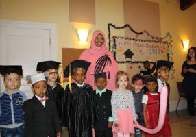 A group of graduates gather with one of the instructors