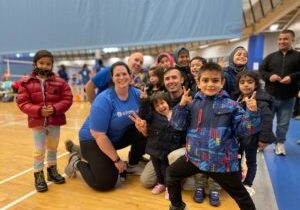 Hadayat Rahimi (center) with his volleyball colleagues and youth team.