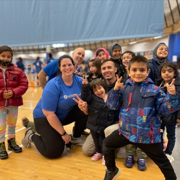 Hadayat Rahimi (center) with his volleyball colleagues and youth team.
