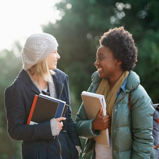 2 students having fun conversation around the campus