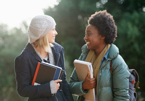 2 students having fun conversation around the campus