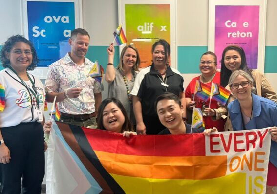 ISANS staff holding big Pride banner