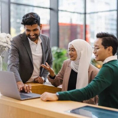 Multicultural group working together in front of laptop