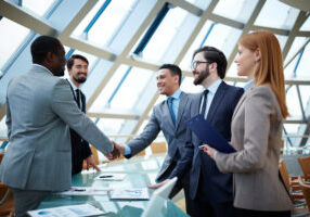 Two businessmen handshaking after striking grand deal